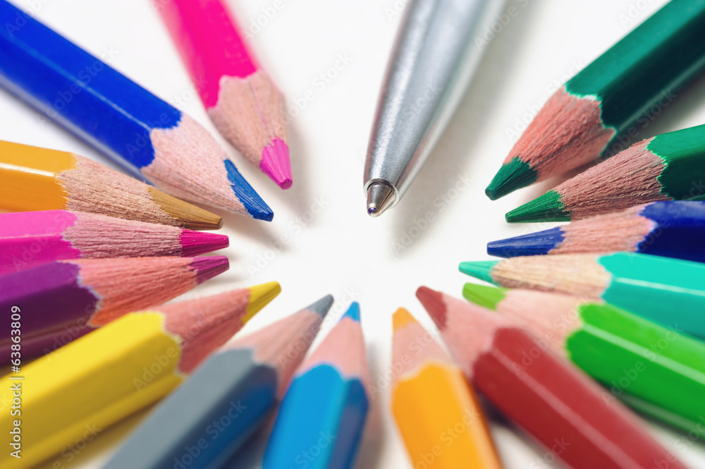 Metal pen among color pencils on light background Metal pen among color pencils on light background