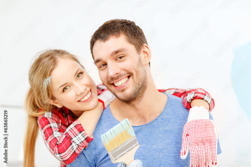 smiling couple covered with paint with paint brush smiling couple covered with paint with paint brush