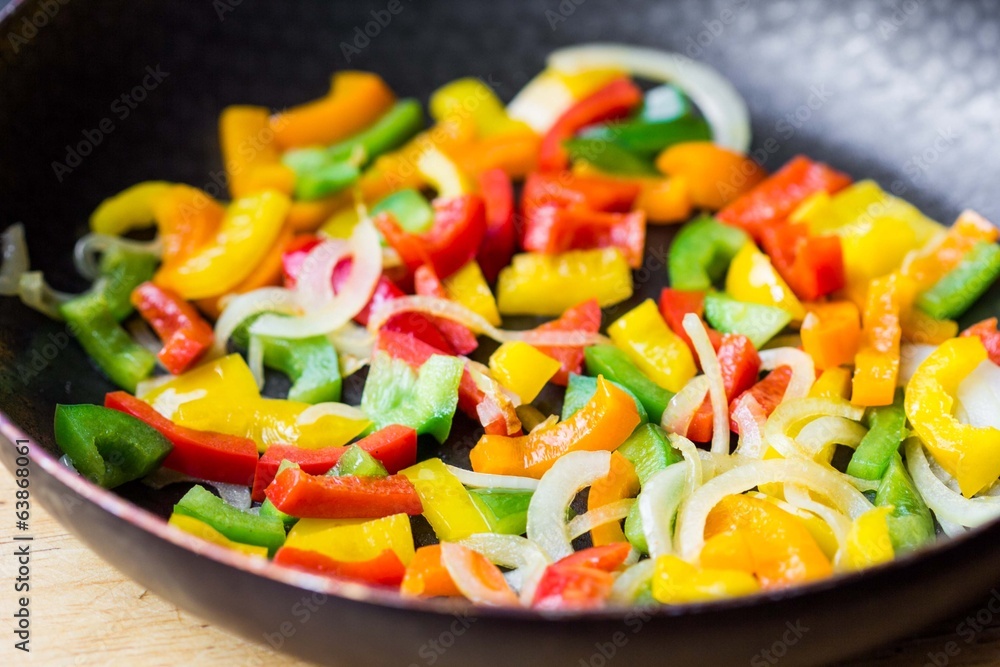 Mixed colorful peppers paprica fried in pan