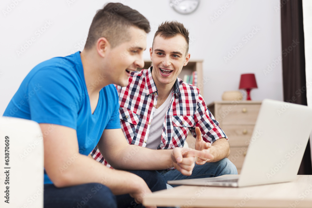 The best male friends spending time together with laptop