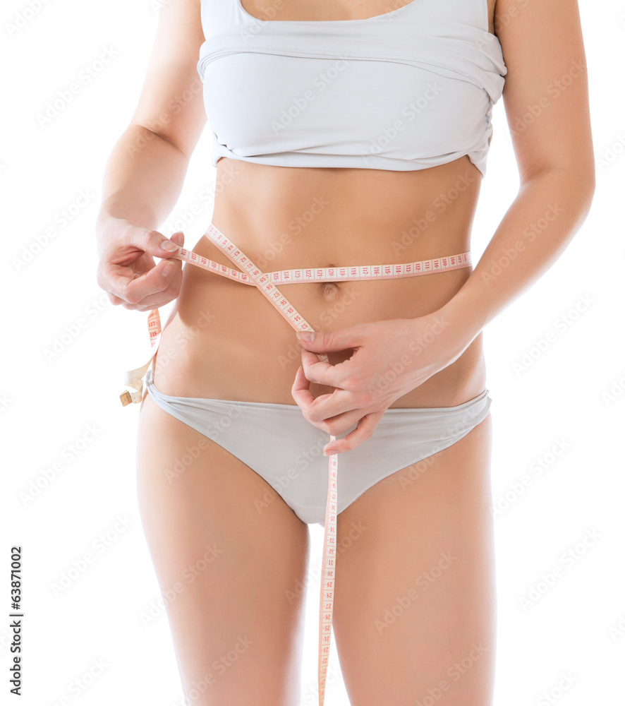 Dietting weight loss concept. Slim woman measuring waist