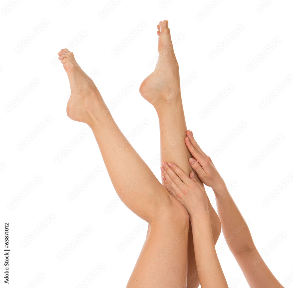 Woman touching hands and legs with french manicured nails Woman touching hands and legs with french manicured nails