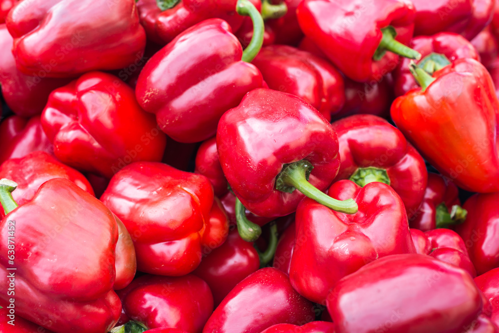 Shiny sweet peppers in a market stall