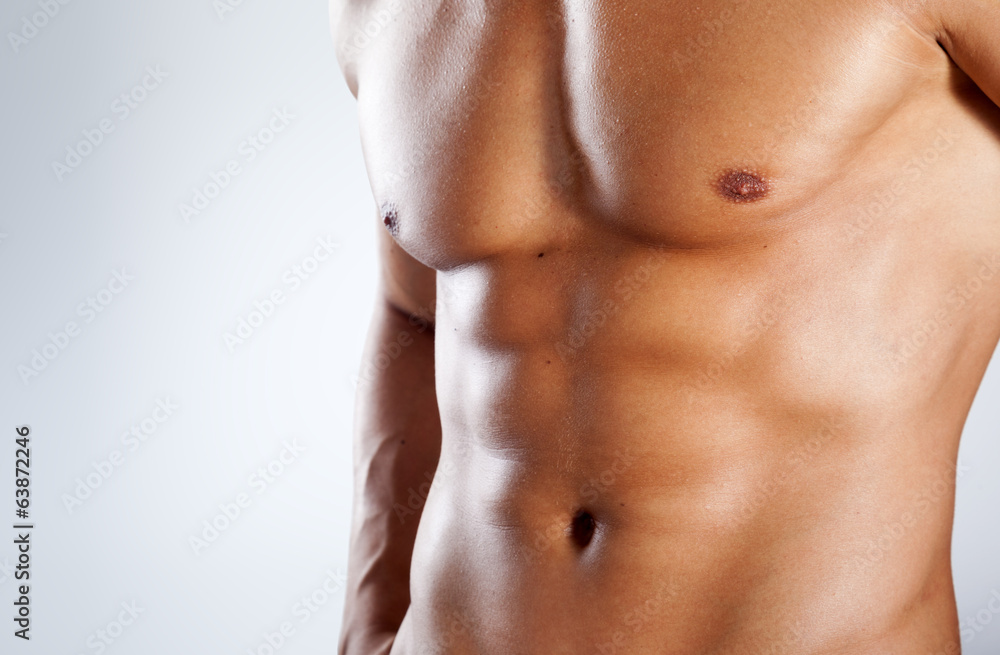 Healthy muscular young man on grey background Healthy muscular young man on grey background