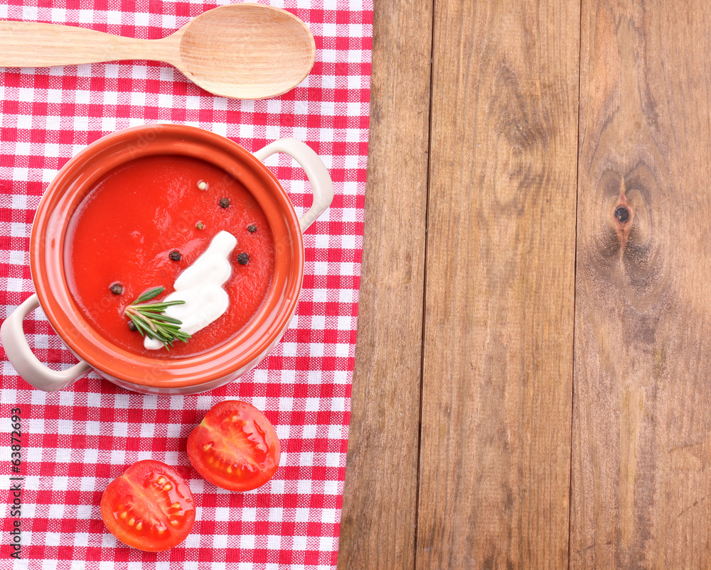 Tasty tomato soup on wooden table Tasty tomato soup on wooden table