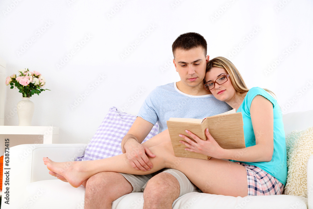 Beautiful couple reading on sofa