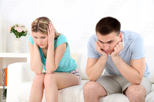 Portrait of young man and woman conflict sitting