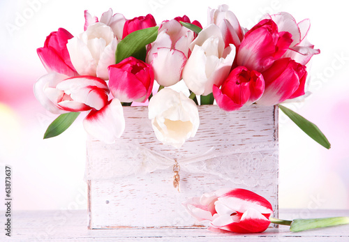Fototapeta Naklejka Na Ścianę i Meble -  Beautiful tulips  in wooden box, on light background