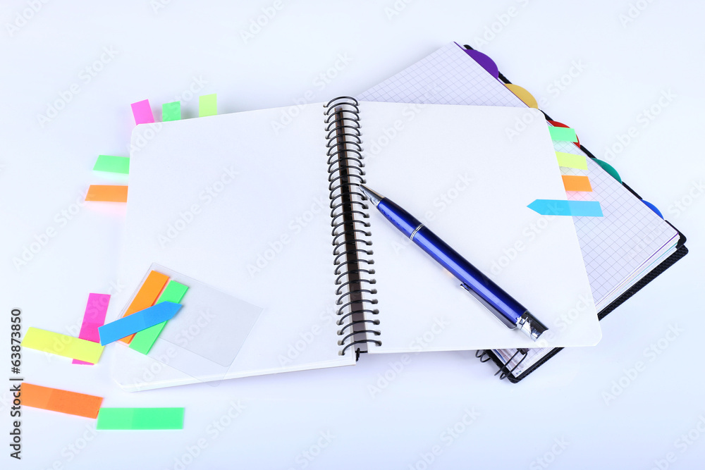 Notebook, pen, and stickers isolated on white