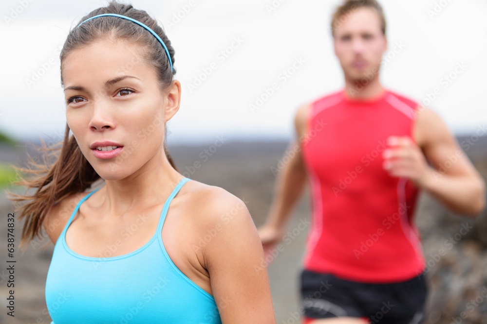 Woman runner closeup - running couple Woman runner closeup - running couple