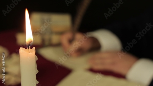 Chronicler writes in the candlelight