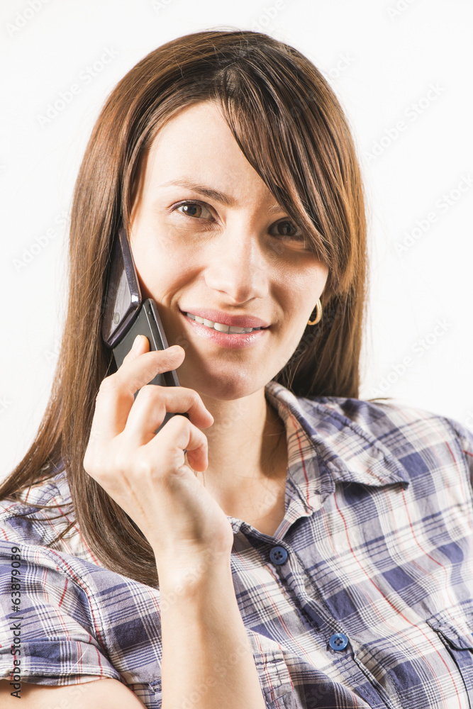 Young women talking on the phone smiling on white background Young women talking on the phone smiling on white background