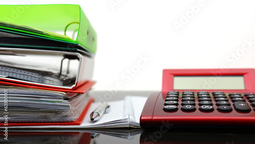accounting concept with binders, folders,notebook, pen and calcu