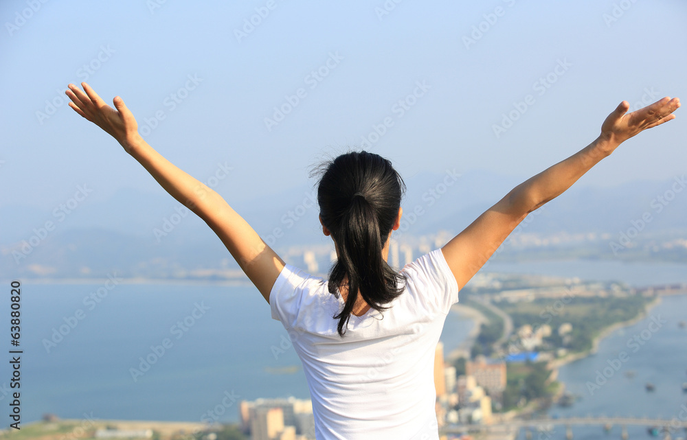 cheering woman pen arms at seaside mountain peak cheering woman pen arms at seaside mountain peak