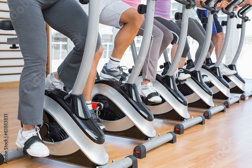 Low section of people working out at spinning class