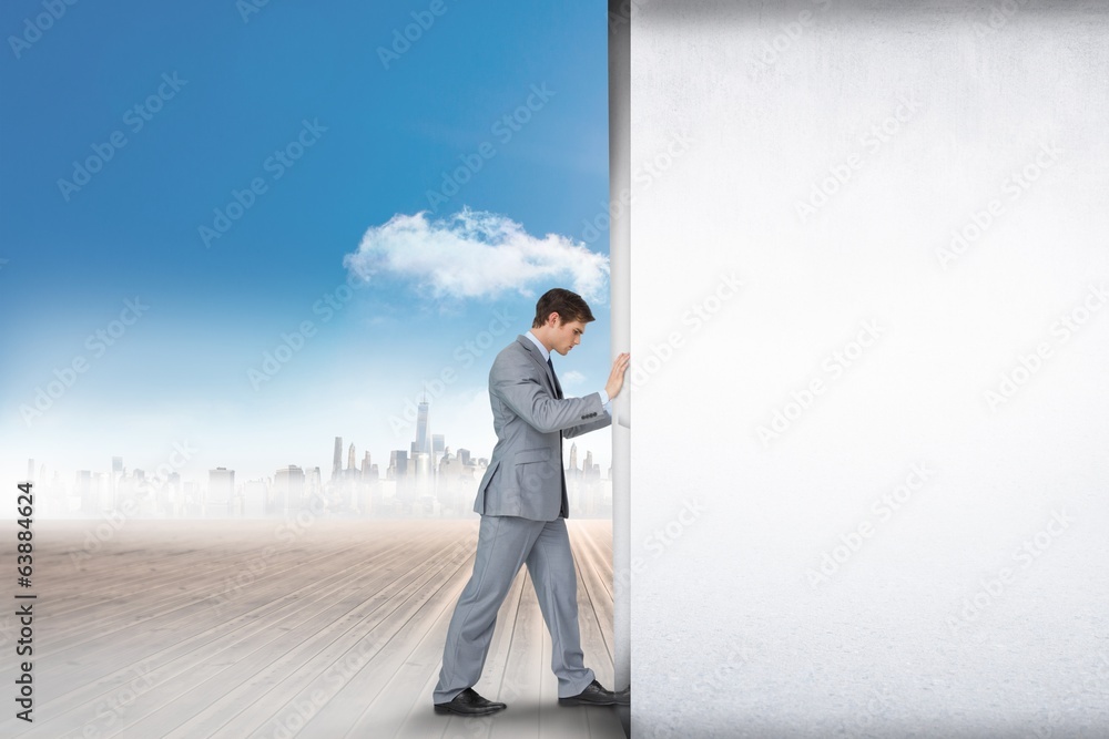 Fototapeta premium Composite image of businessman pushing away scene