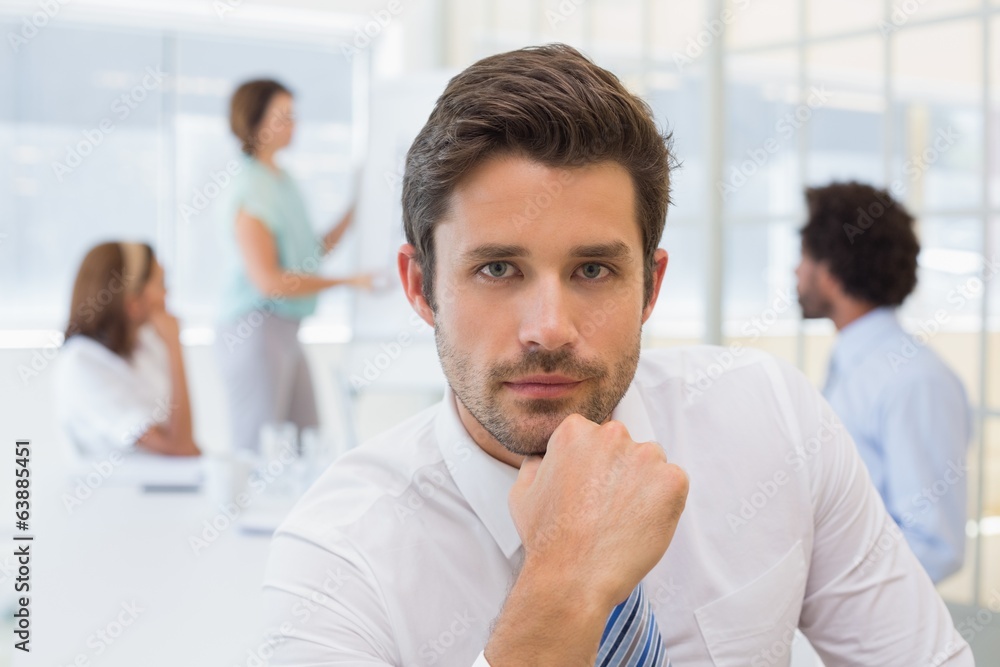 Serious businessman with colleagues in meeting at office Serious businessman with colleagues in meeting at office
