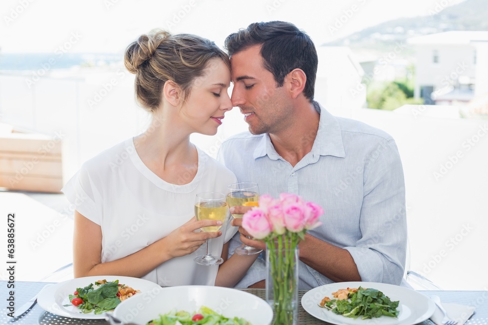 Loving couple toasting wine glasses at lunch table Loving couple toasting wine glasses at lunch table