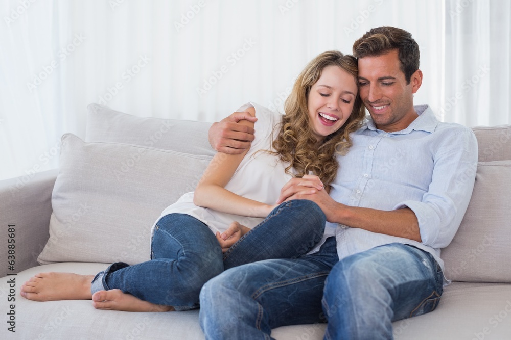 Portrait of a loving couple sitting on couch Portrait of a loving couple sitting on couch