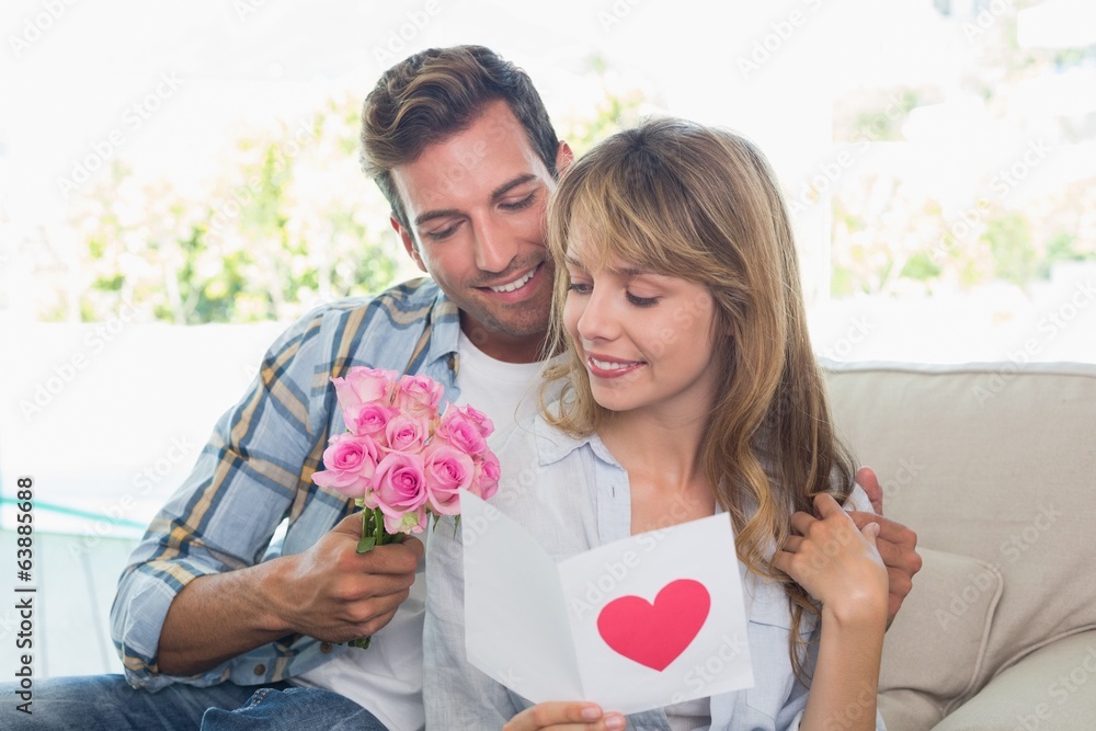 Loving couple with flowers and greeting card Loving couple with flowers and greeting card