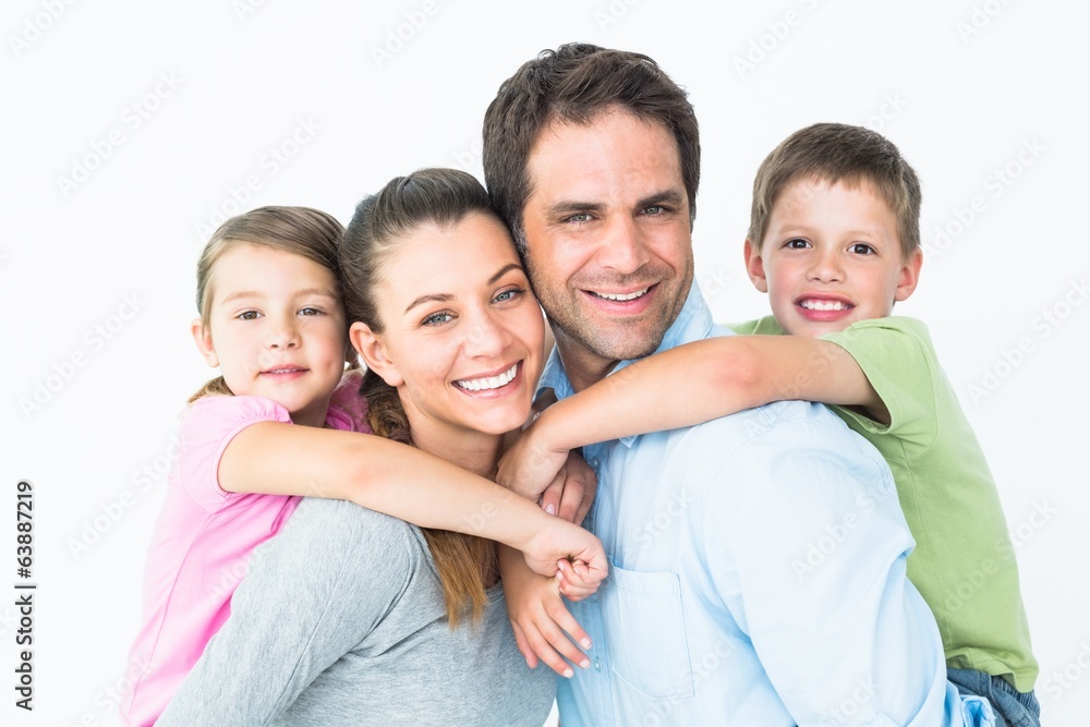 Happy young family looking at camera together Happy young family looking at camera together