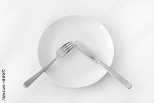 White plate with fork and knife.