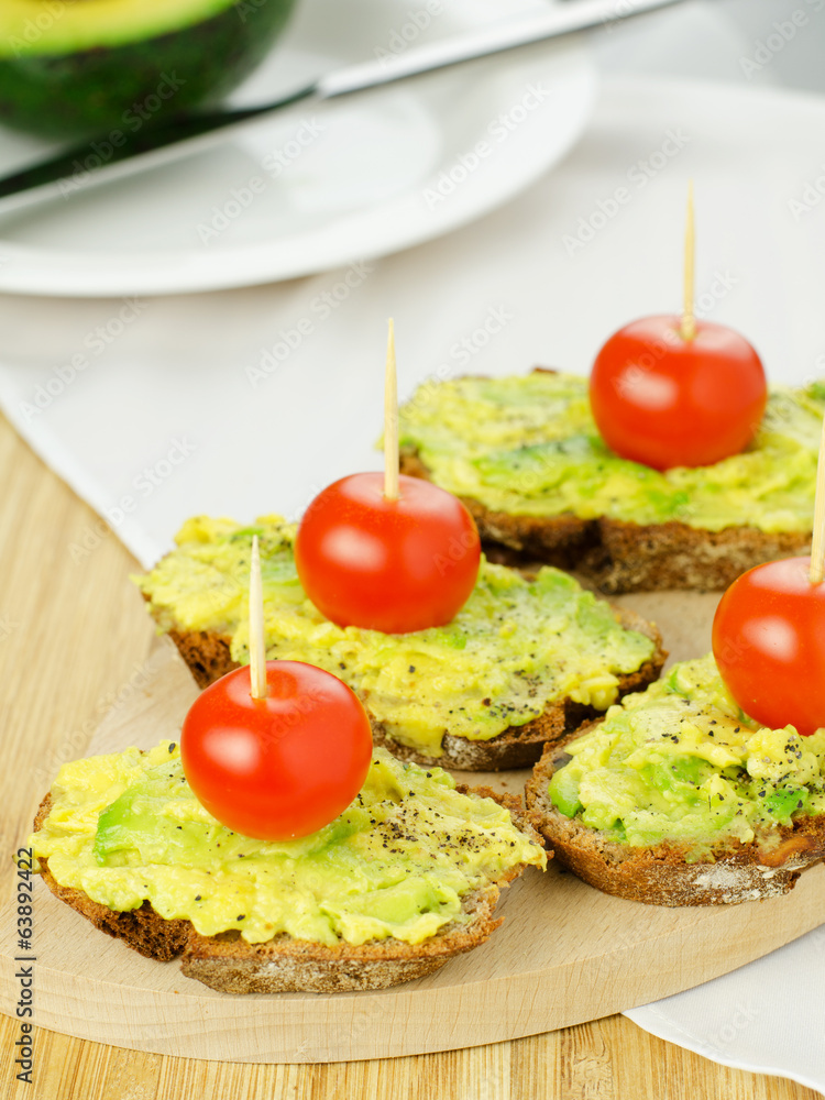 Avocado with tomatoes on seed bread Avocado with tomatoes on seed bread
