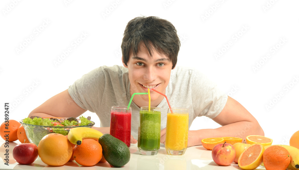 Man having a table full of organic food,juices, smoothie, salad Man having a table full of organic food,juices, smoothie, salad