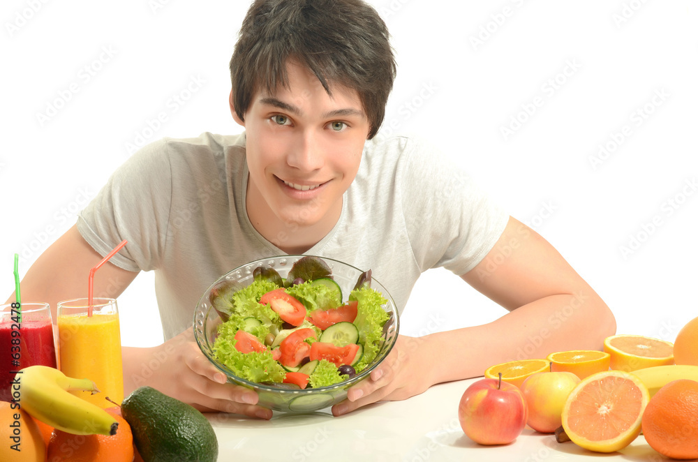 Man having a table full of organic food,juices, smoothie, salad Man having a table full of organic food,juices, smoothie, salad