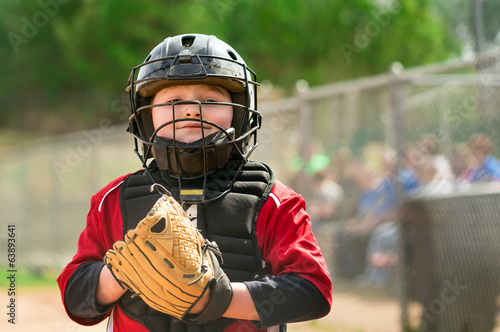 Portrait of child baseball player wearing catcher gear