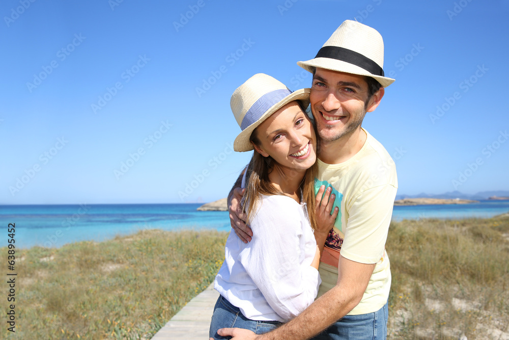 Portrait of sweet couple embracing by the beach