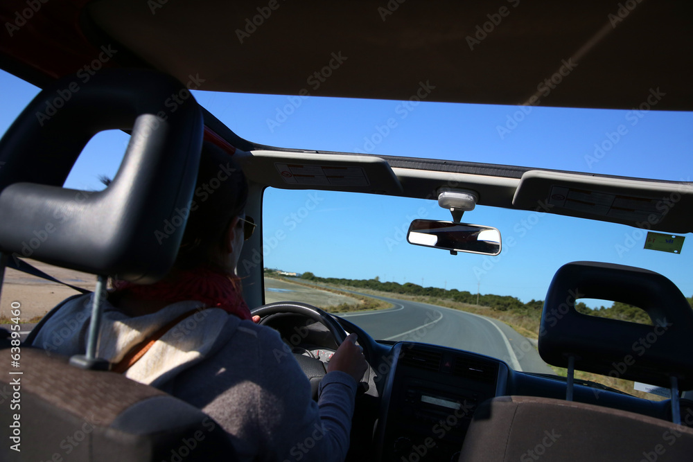 Back view of woman driving car Back view of woman driving car