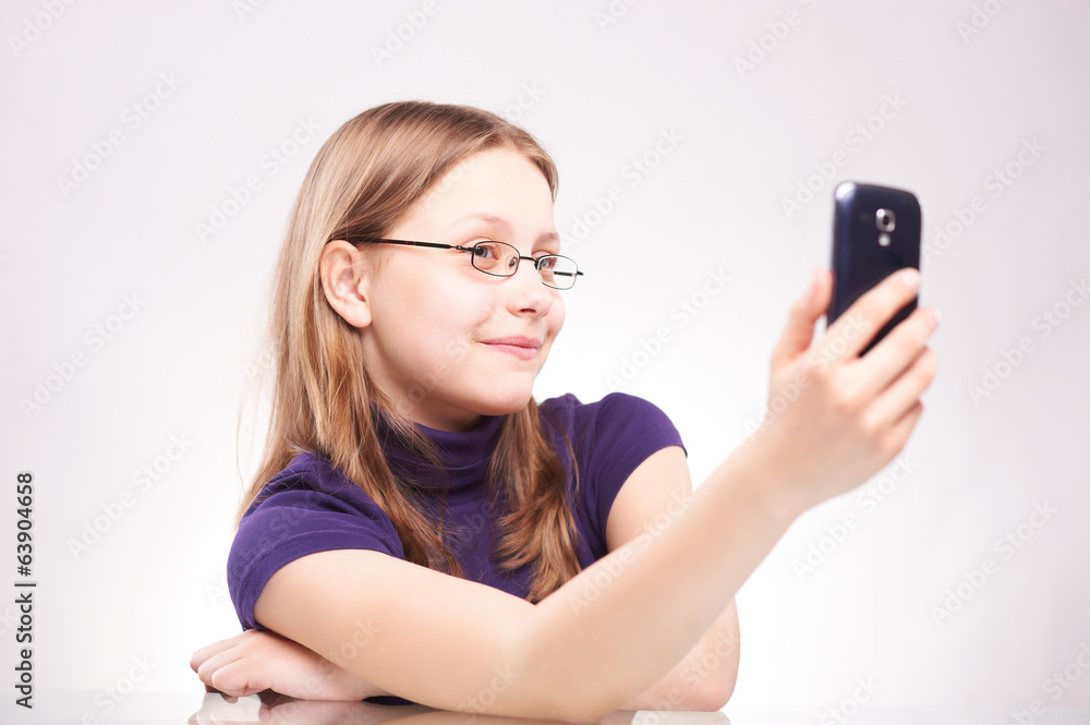 Portrait of a cute teen girl with phone taking selfie Portrait of a cute teen girl with phone taking selfie