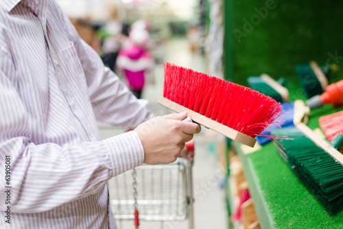 closeup on business man selecting a sweeping broom