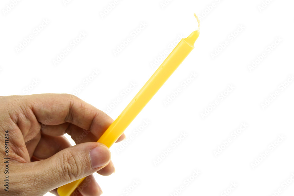 Hand hold yellow candle for lit from bottom left isolated Hand hold yellow candle for lit from bottom left isolated