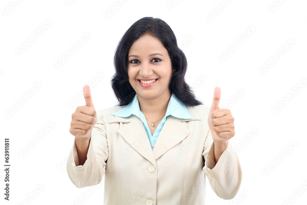 Smiling businesswoman showing thumbs up isolated against white b Smiling businesswoman showing thumbs up isolated against white b