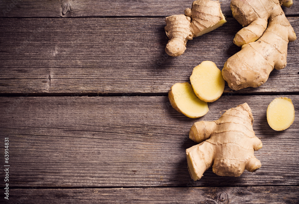 Ginger root sliced on wooden background Ginger root sliced on wooden background
