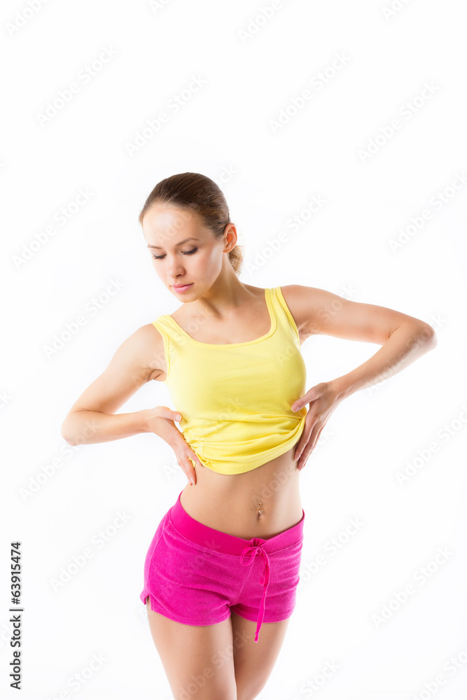Happy young woman with beautiful slim body in yellow sport cloth Happy young woman with beautiful slim body in yellow sport cloth