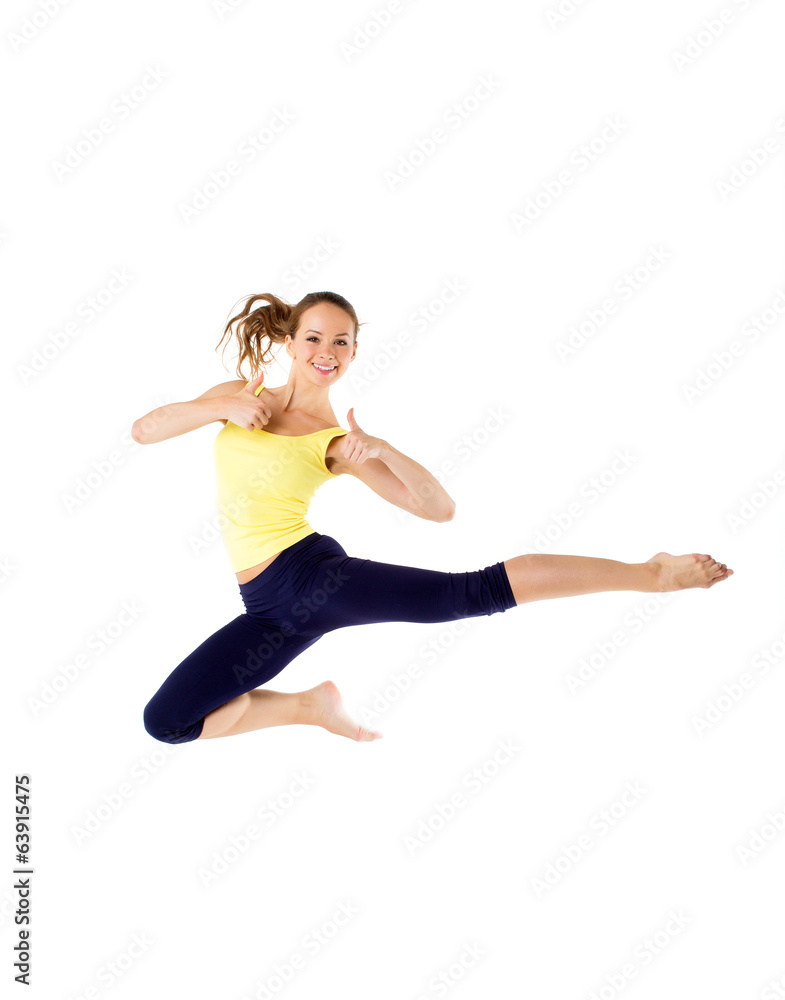 Beautiful sporty woman jumping on a white background