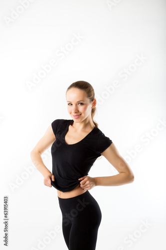 Young woman fitness. In the black sports clothes on white backgr