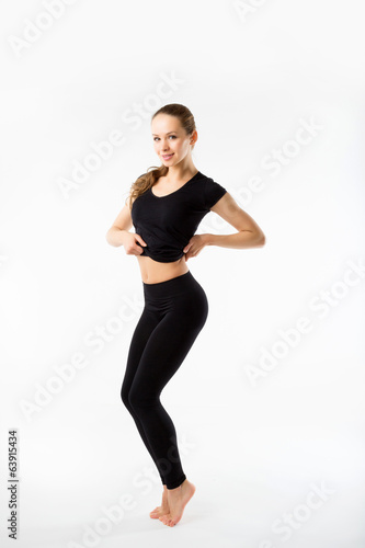 Young woman doing aerobics and stretching, isolated on white bac