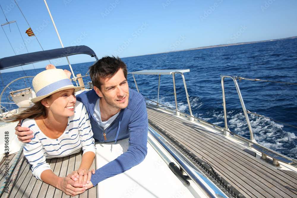 Couple enjoying cruising on sailboat