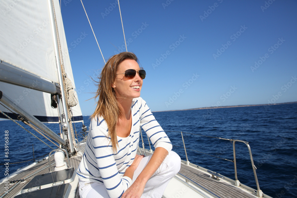 Fototapeta premium Attractive modern woman enjoying sailing cruise