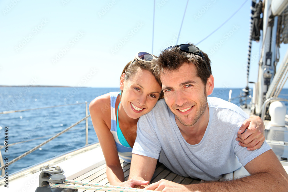 Couple relaxing on sailboat deck