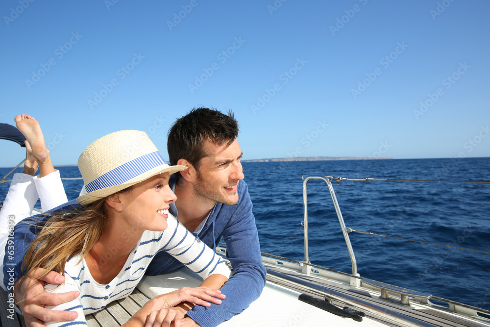 Couple enjoying cruising on sailboat