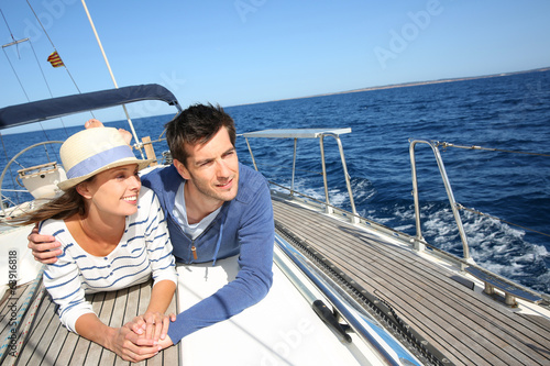 Couple enjoying cruising on sailboat © goodluz