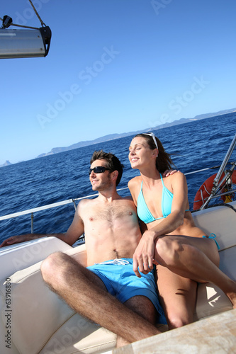 Lucky couple relaxing on sailboat deck © goodluz