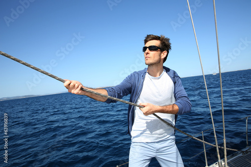 Skipper lifting sails up
