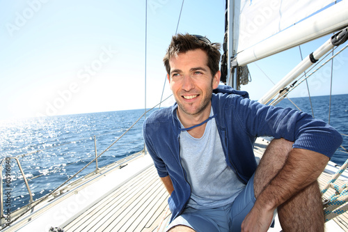 Smiling handsome man on sailboat