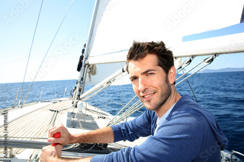 Man sailing with sails out on a sunny day photo